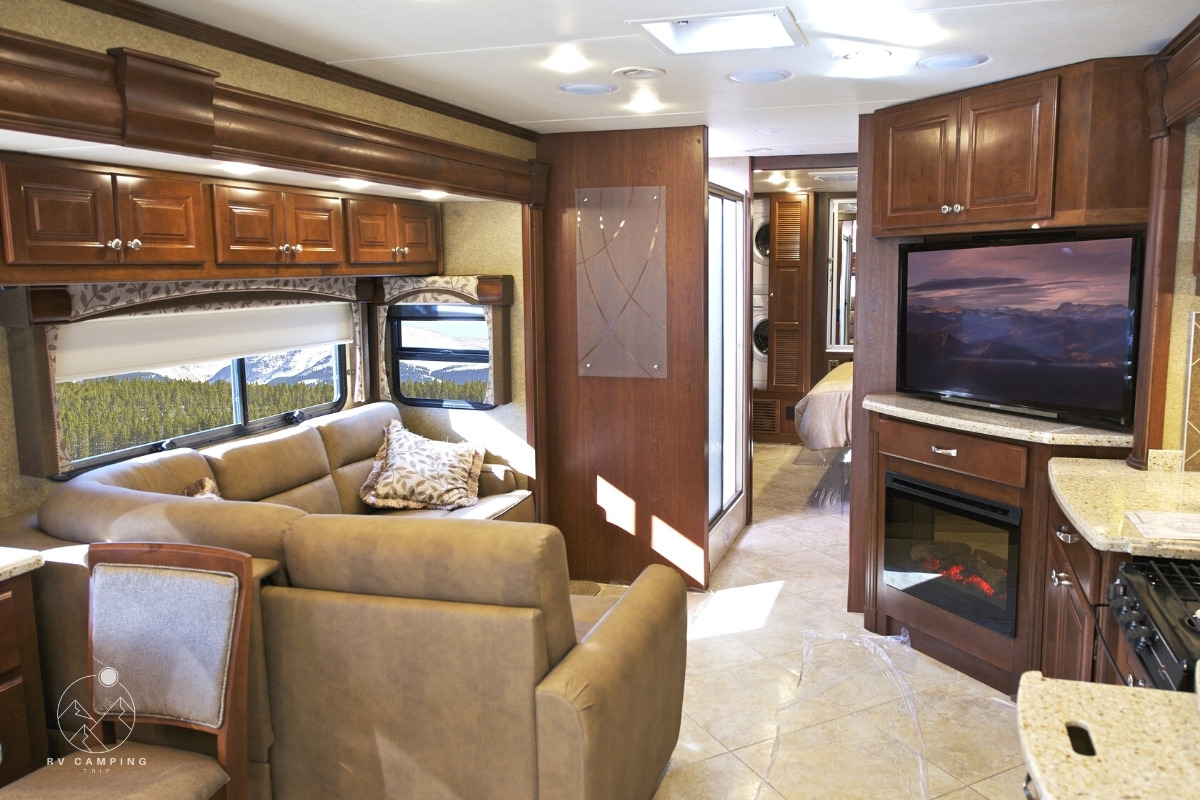 interior of a class a motorhome with a large LED TV and fireplace