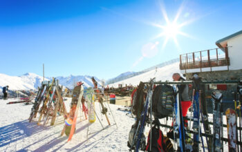sun shining over ski resort racks